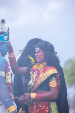 Kulashekharapatnam, Tamilnadu, India - October 11, 2024: Kulasai, Portrait of indian hindu devotee with painted face and dressed as goddess kali to perform the rituals of kulasai dasara cult festival. clipart