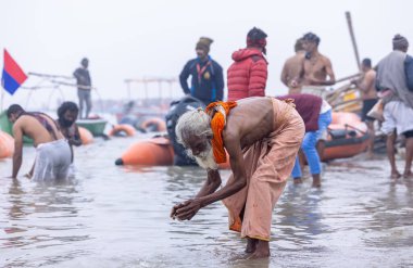 Prayagraj, Uttar Pradesh, Hindistan - 14 Ocak 2025: Mahakumbh, Mahakumbh, kutsal sadhu grubu ve dindarlar Sangam 'daki Ganga Nehri' ne doğru yürüyorlar..
