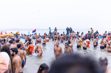 Prayagraj, Uttar Pradesh, India - January 14 2025: Mahakumbh, Group of holy sadhu and devotees marching towards the river ganga at sangam to take the holy dip during the makar sankranti in mahakumbh. clipart