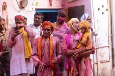 Barsana, Uttar Pradesh, Hindistan - 18 Mart 2024: Nandgaon 'dan Hindu erkek portresi Kafasını deri bir kalkanla koruyor Barsana' lı bir kadın tarafından bir lathmar holi geleneği olarak vurulan bambu çubuğu