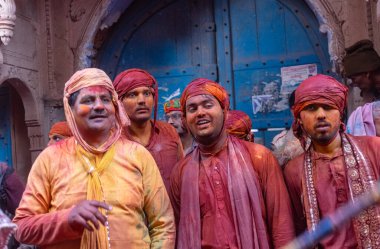 Barsana, Uttar Pradesh, Hindistan - 18 Mart 2024: Nandgaon 'dan Hindu erkek portresi Kafasını deri bir kalkanla koruyor Barsana' lı bir kadın tarafından bir lathmar holi geleneği olarak vurulan bambu çubuğu