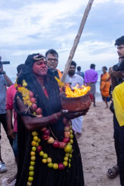 Kulashekharapatnam, Tamilnadu, Hindistan - 11 Ekim 2024: Hint Hindu dindar, yüzü boyalı ve tarikat karakteri gibi giyinmiş, kulasai dasara festivalini akşam ateşle gerçekleştirmek için.