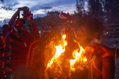 Kulashekharapatnam, Tamilnadu, Hindistan - 11 Ekim 2024: Hint Hindu dindar, yüzü boyalı ve tarikat karakteri gibi giyinmiş, kulasai dasara festivalini akşam ateşle gerçekleştirmek için.