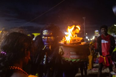 Kulashekharapatnam, Tamilnadu, Hindistan - 11 Ekim 2024: Hint Hindu dindar, yüzü boyalı ve tarikat karakteri gibi giyinmiş, kulasai dasara festivalini akşam ateşle gerçekleştirmek için.