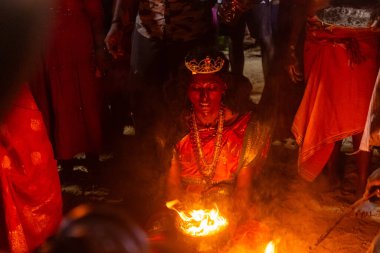 Kulashekharapatnam, Tamilnadu, Hindistan - 11 Ekim 2024: Hint Hindu dindar, yüzü boyalı ve tarikat karakteri gibi giyinmiş, kulasai dasara festivalini akşam ateşle gerçekleştirmek için.