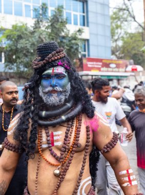 Varanasi, Uttar Pradesh, Hindistan - 20 Mart 2024: Masan Holi, Masan Holi, Masan Holi, Harishchandra ghat 'taki masaan holi kutlamaları sırasında tanrıça Kali olarak resmedilen bir kadın ressamın portresi.