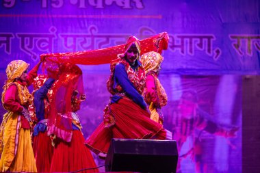 Pushkar, Rajasthan, Hindistan - 11 Kasım 2024: Bhangra, Sih erkek sanatçılar grubu renkli etnik elbiseler içinde bhangra dansı yapıyorlar..
