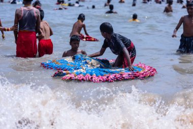 Kulashekharapatnam, Tamilnadu, Hindistan - 12 Ekim 2024: Kulasai Dasara, bir grup çocuk ve ebeveynleri kulasai dasara festivalinde deniz dalgalarının keyfini çıkarıyorlar.