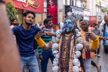 Varanasi, Uttar Pradesh, Hindistan - 20 Mart 2024: Masan Holi, Harishchandra ghat 'ta düzenlenen kutlama sırasında efendi shiva gibi giyinmiş kuru külle boyanmış bir erkek dindar portresi.