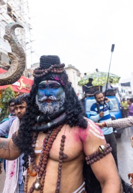 Varanasi, Uttar Pradesh, Hindistan - 20 Mart 2024: Masan Holi, Harishchandra ghat 'ta düzenlenen kutlama sırasında efendi shiva gibi giyinmiş kuru külle boyanmış bir erkek dindar portresi.