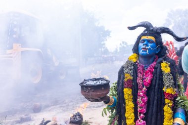 Varanasi, Uttar Pradesh, Hindistan - 20 Mart 2024: Masan Holi, Masan Holi, Masan Holi, Harishchandra ghat 'taki masaan holi kutlamaları sırasında tanrıça Kali olarak resmedilen bir kadın ressamın portresi.