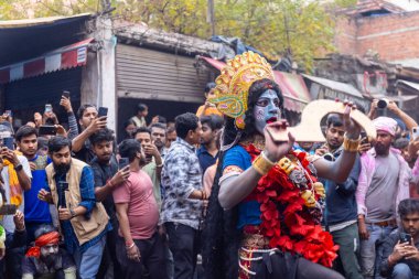 Varanasi, Uttar Pradesh, Hindistan - 20 Mart 2024: Masan Holi, Masan Holi, Masan Holi, Harishchandra ghat 'taki masaan holi kutlamaları sırasında tanrıça Kali olarak resmedilen bir kadın ressamın portresi.