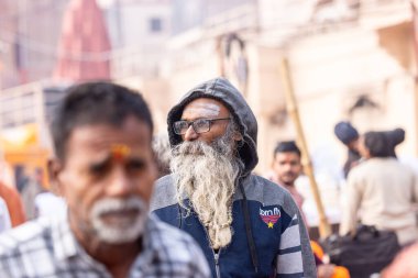 Varanasi, Uttar Pradesh, Hindistan - 20 Ocak 2024: Varanasi 'deki çetelerin yakınında dikilen geleneksel Hint turist portresi. Dünyanın dört bir yanındaki turistler moksha ve Yoga için Varanasi 'yi ziyaret ediyorlar.. 