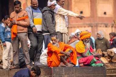 Varanasi, Uttar Pradesh, Hindistan - 20 Ocak 2024: Varanasi 'deki çetelerin yakınında dikilen geleneksel Hint turist portresi. Dünyanın dört bir yanındaki turistler moksha ve Yoga için Varanasi 'yi ziyaret ediyorlar..
