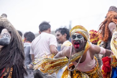Varanasi, Uttar Pradesh, Hindistan - 20 Mart 2024: Masan Holi, Harishchandra ghat 'ta düzenlenen kutlama sırasında efendi shiva gibi giyinmiş kuru külle boyanmış bir erkek dindar portresi.