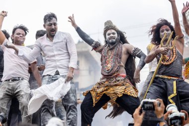 Varanasi, Uttar Pradesh, Hindistan - 20 Mart 2024: Masan Holi, Harishchandra ghat 'ta düzenlenen kutlama sırasında efendi shiva gibi giyinmiş kuru külle boyanmış bir erkek dindar portresi.