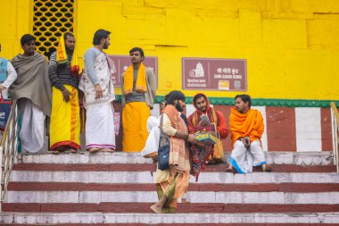 Varanasi, Uttar Pradesh, Hindistan - 20 Ocak 2024: Gurukul 'un kimliği belirsiz genç öğrencileri veya Varanasi' de kış sabahı kutsal nehir gangası yakınlarındaki Kedar Tapınağı 'nda duran bir grup öğrenci.