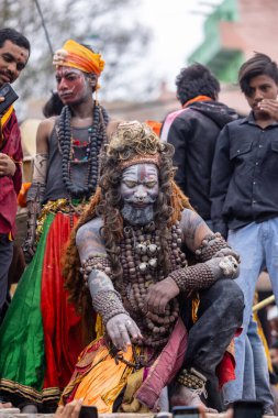 Varanasi, Uttar Pradesh, Hindistan - 20 Mart 2024: Masan Holi, Harishchandra ghat 'ta düzenlenen kutlama sırasında efendi shiva gibi giyinmiş kuru külle boyanmış bir erkek dindar portresi.
