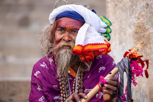 Varanasi, Uttar Pradesh, Hindistan - 20 Ocak 2024: Varanasi 'deki çetelerin yakınındaki ghatlarda oturan geleneksel bir sadhu baba resmi. Sadhu, Kaşhi 'de Ganga yakınlarında ayinler düzenler..