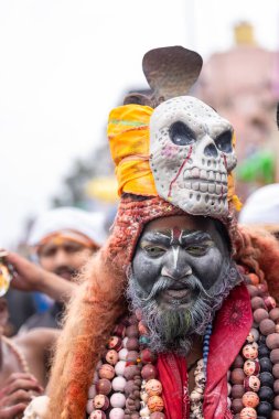 Varanasi, Uttar Pradesh, Hindistan - 20 Mart 2024: Masan Holi, Harishchandra ghat 'ta düzenlenen kutlama sırasında efendi shiva gibi giyinmiş kuru külle boyanmış bir erkek dindar portresi.