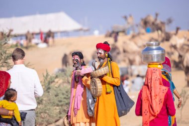 Pushkar, Rajasthan, India - November 10, 2024: Portrait of rajasthani male in traditional clothes at desert fairground during the pushkar camel fair for trading camels.