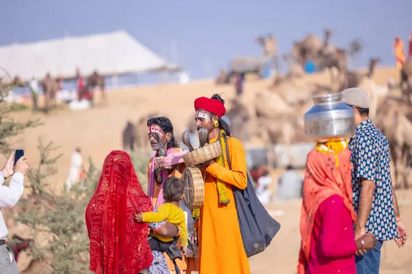 Pushkar, Rajasthan, India - November 10, 2024: Portrait of rajasthani male in traditional clothes at desert fairground during the pushkar camel fair for trading camels.