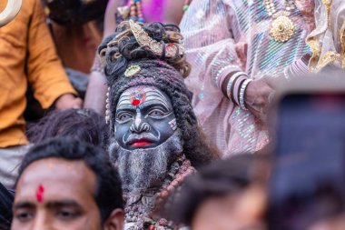 Varanasi, Uttar Pradesh, Hindistan - 21 Mart 2024: Masan Holi, Harishchandra ghat 'ta düzenlenen kutlama sırasında Lord Shiva gibi giyinmiş kuru külle boyanmış yüzü olan bir dindar..