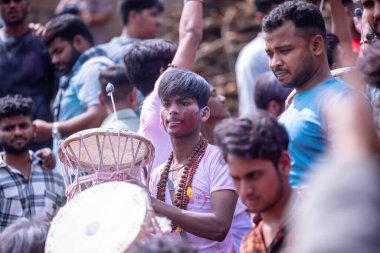 Varanasi, Uttar Pradesh, Hindistan - 21 Mart 2024: Masan Holi, Masan Holi, Mankarnika ghat 'ta İstanbul Holi festivaline katılan ve Damru oynayan isimsiz dindarlar grubu.