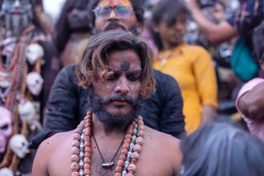 Varanasi, Uttar Pradesh, Hindistan - 21 Mart 2024: Masan Holi, Harishchandra ghat 'ta düzenlenen kutlama sırasında Lord Shiva gibi giyinmiş kuru külle boyanmış yüzü olan bir dindar..