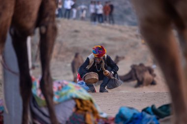 Pushkar, Rajasthan, India - November 10, 2024: Portrait of a rajasthani male in traditional clothes at desert fairground during the pushkar camel fair for trading camels.