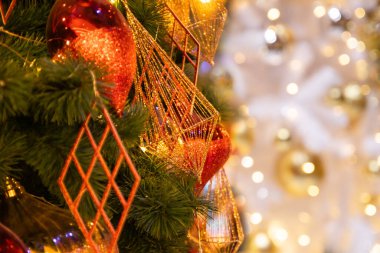 Xmas şenlik kompozisyonu, parlak altın ve kırmızı toplarla süslenmiş Noel ağacını kapat güzel iç tasarım, bulanık odaklanmamış parlak bokeh arka plan, altın renkli yeni yıl tatili