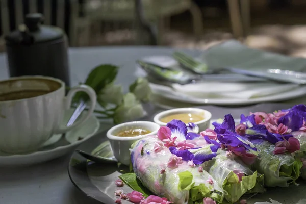 The evening Tea time, coffee break with healthy vegetable and flowers salad role, dressing and coffee
