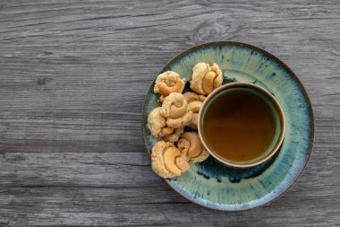 Ahşap arka planda çay ve kurabiye, Kurabiyeli bir fincan çayın üst görünümü, kopyalama alanı. 