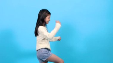 Asian happy kid spent time with music showing her step with cheerful, cute school element girl lifestyle dancing with energetic and fun, young kid lifestyle talent or extraordinary capability concept