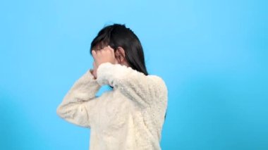 Asian girl closes her ears upset to hear a loud noise or parent fighting, adorable young kid suffering from illness or stress gets a headache and going to cry, kid problem solving by ignoring awareness outside