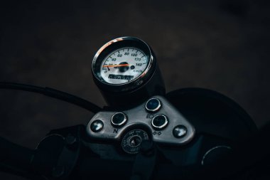 Sadece editörler kullanır. Turuncu ve beyaz renkli bir klasik Suzuki motosikleti, Ukrayna 'nın Kyiv kentinde yemyeşil ağaçlar ve yeşilliklerle çevrili sessiz bir caddeye park edilmiştir..