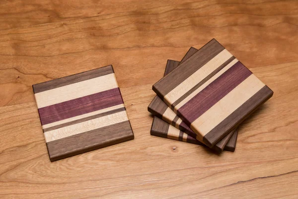Set Four Hardwood Coasters Different Layers Maple Walnut Purple Heart — Stock Photo, Image