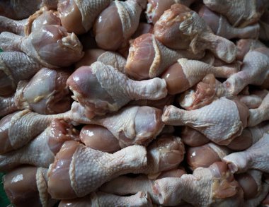 Raw chicken legs big heap background