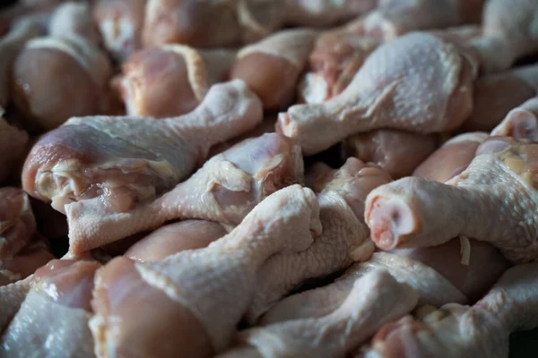 Raw chicken legs big heap background