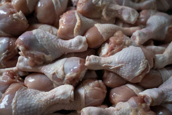 Raw chicken legs big heap background