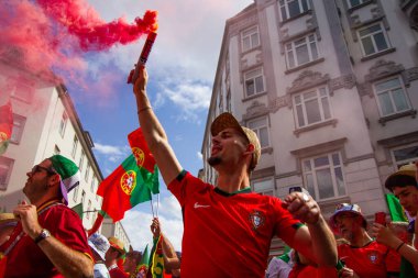 Hamburg, Germany - July 5, 2024: Portuguese fans celebrating Euro 2024 in the streets of the city clipart