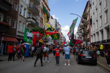 Hamburg, Germany - July 5, 2024: Portuguese fans celebrating Euro 2024 in the streets of the city clipart