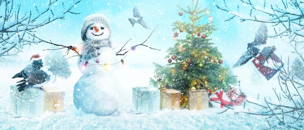Happy snowman standing in winter christmas landscape.