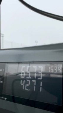 Benzin istasyonu fiyat sayacı. Bir arabanın yakıt ikmali sırasında yakın çekim. Benzin fiyatlarında artış ya da azalma. İspanya