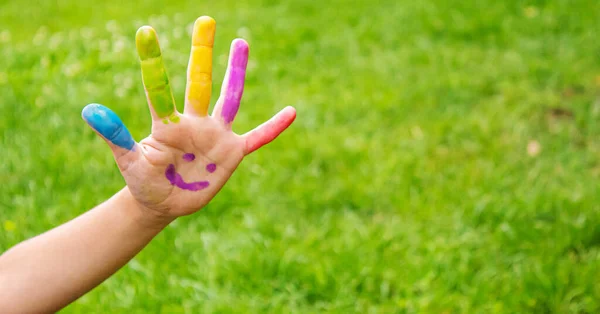 Children\'s hands in the colors of summer. Selective focus.arts