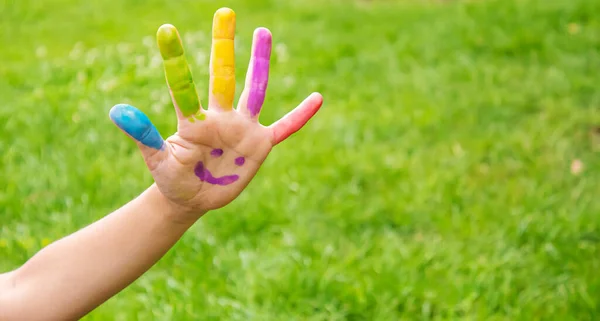 Children\'s hands in the colors of summer. Selective focus.arts