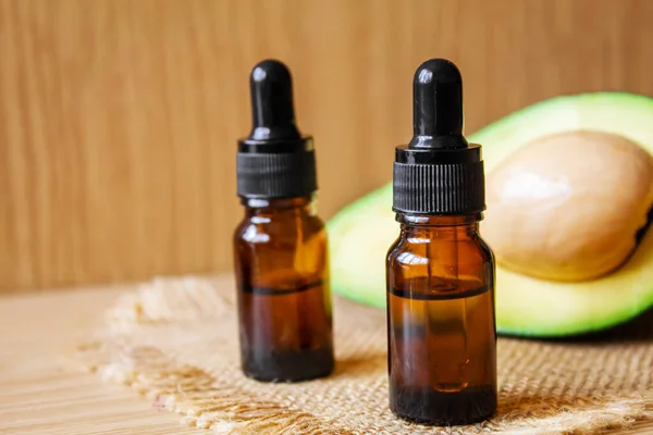 stock image Avocado and avocado oil on wooden background. Selective focus.food