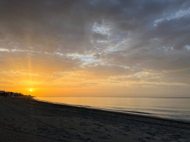 Sunrise at the beach around Nerja Spain clipart