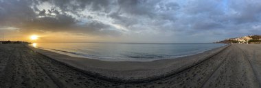 Panorama from sunrise at the beach around Nerja Spain clipart