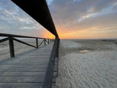 Sunset at the Beach of Conil de la Frontera in Spain clipart